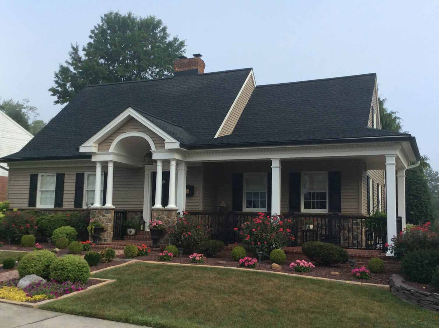 Dark architectural shingle roof completed by JMA Exteriors